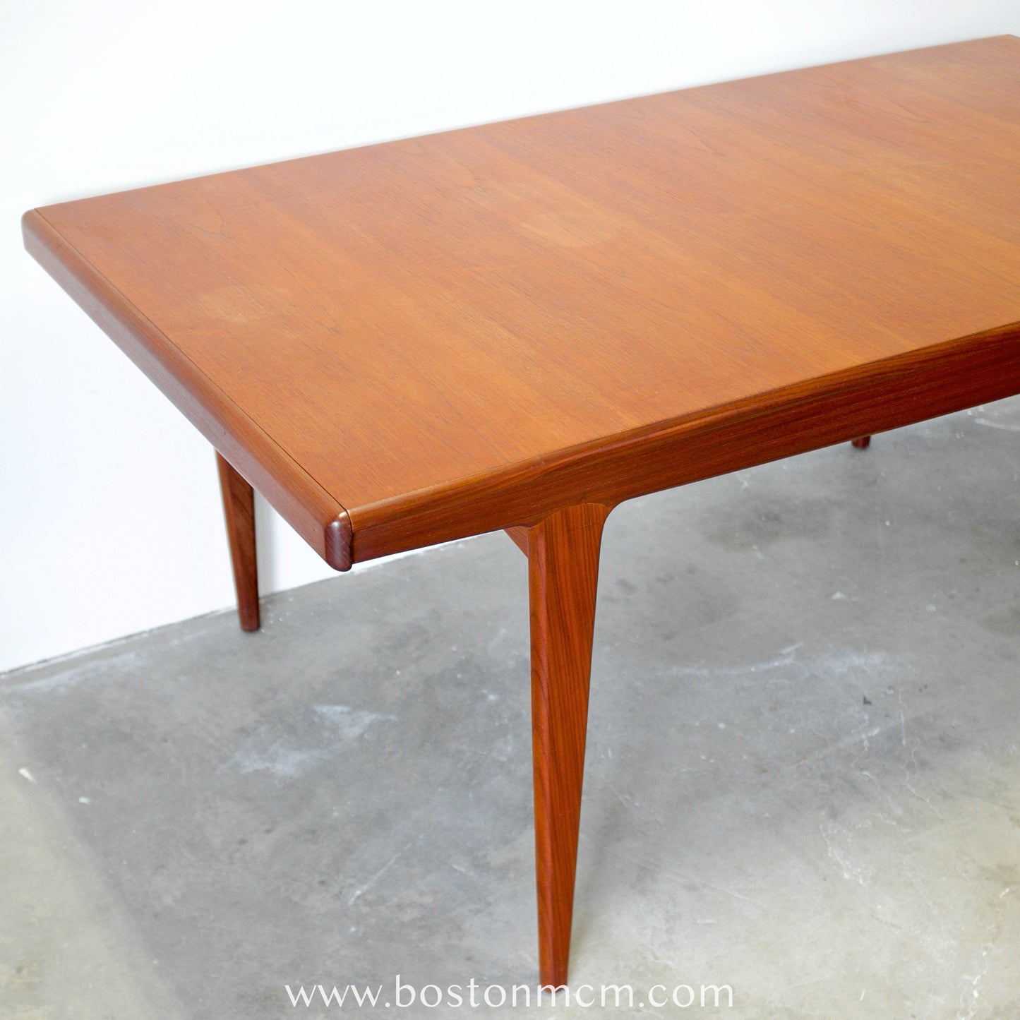 A. Younger Furniture Teak Dining Table with Hidden Leaves