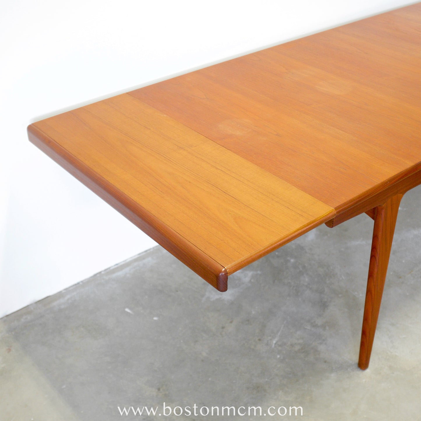 A. Younger Furniture Teak Dining Table with Hidden Leaves