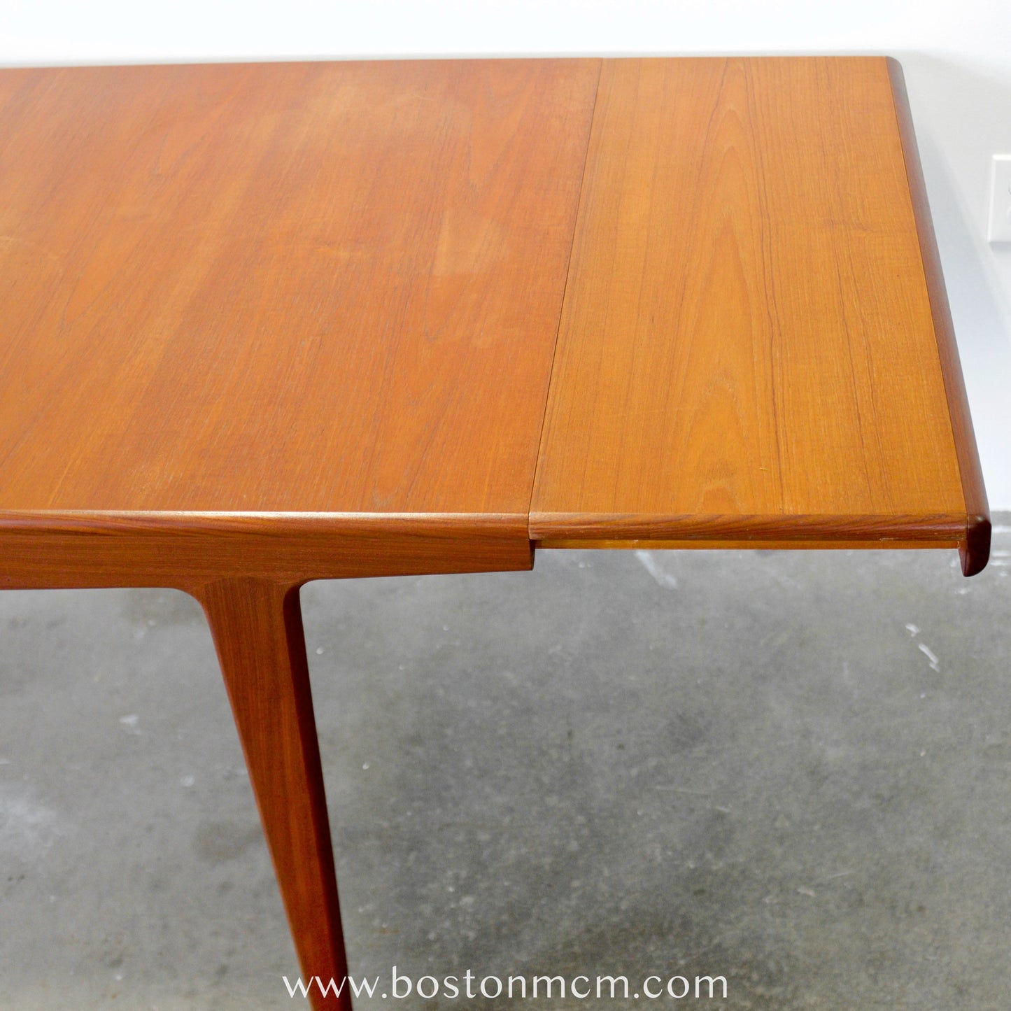 A. Younger Furniture Teak Dining Table with Hidden Leaves